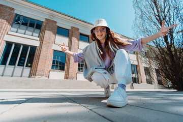 Closeup girl staring at camera. Portrait of charming female person dancing on the street