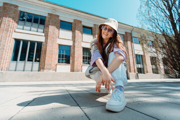 Beautiful and happy European girl having fun dancing break dance hip hop freestyle outdoors.