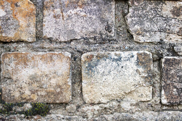 The wall is made of old dirty white brick
