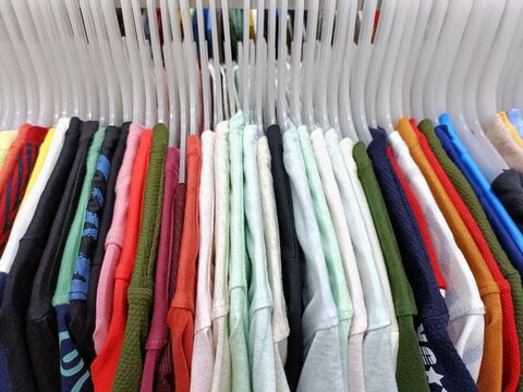 colorful shirts on hangers for sale
