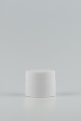 Unbranded white plastic jar for cosmetics products. Skincare and cosmetology vertical mockup. Branding identity template for text and design