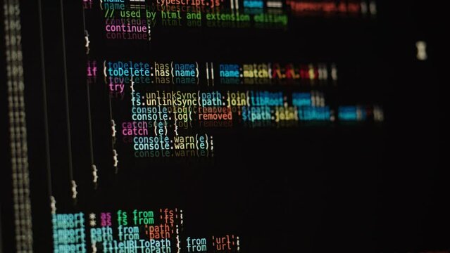 Programmer using laptop. Program code and script data on the screen close-up. Hacker attack. 
