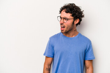 Fototapeta premium Young caucasian man isolated on white background shouting very angry, rage concept, frustrated.