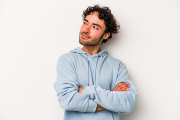 Young caucasian man isolated on white background dreaming of achieving goals and purposes