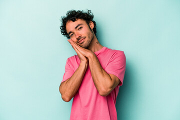 Young caucasian man isolated on white background yawning showing a tired gesture covering mouth with hand.