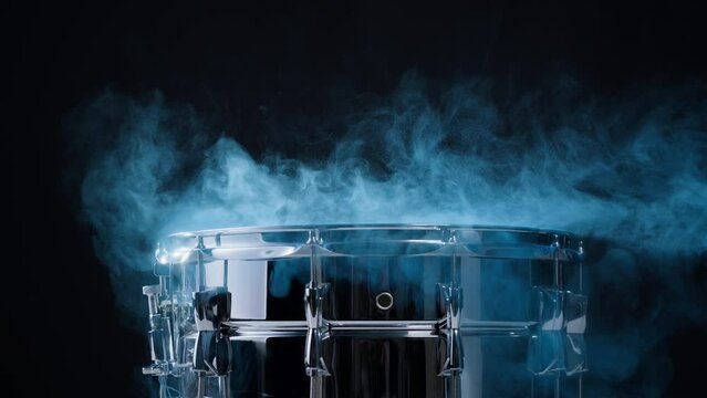 Playing drums with colorful blue powder close-up. Drummer playing musical instrument, professional musician player. 