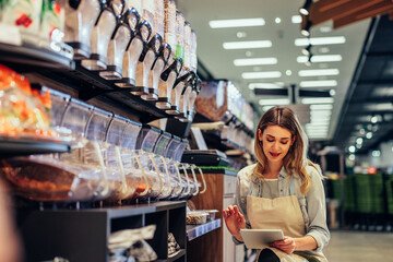 Woman doing the inventory at a supermarket
