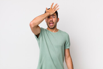 young handsome hicpanic man raising palm to forehead thinking oops, after making a stupid mistake...