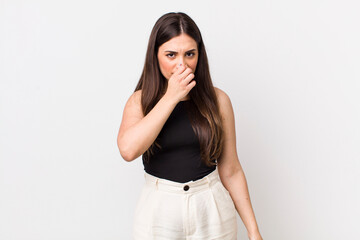 young pretty woman feeling disgusted, holding nose to avoid smelling a foul and unpleasant stench - obrazy, fototapety, plakaty