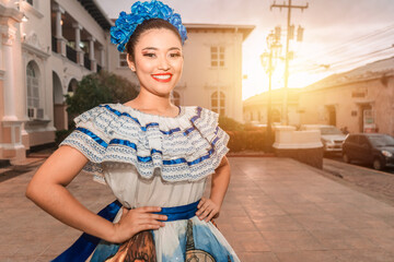 Traditional dance dancer from Nicaragua smiling and looking at the camera at sunset wearing the typical costume of Central America