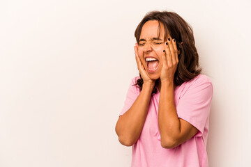 Fototapeta premium Young hispanic woman isolated on white background shouts loud, keeps eyes opened and hands tense.