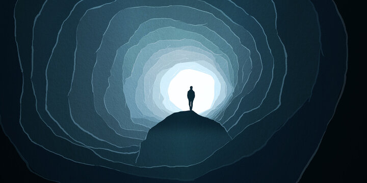 Silhouette of Man rock underground cave deep light