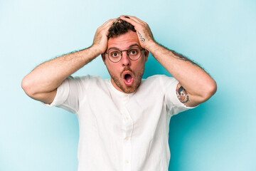 Young caucasian man isolated on blue background surprised and shocked.
