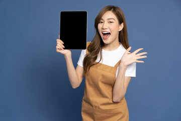 Housekeeping young Asian woman showing screen of tablet isolated on blue background