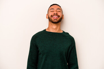 Young hispanic man isolated on white background relaxed and happy laughing, neck stretched showing teeth.