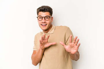 Young caucasian man isolated on white background rejecting someone showing a gesture of disgust.