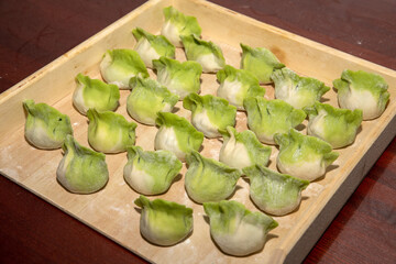 Dumplings made of green vegetable juice and noodles