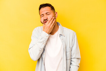 Young hispanic man isolated on yellow background having a strong teeth pain, molar ache.