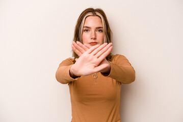 Young caucasian woman isolated on white background doing a denial gesture