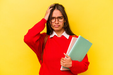 Young student hispanic woman isolated on yellow background being shocked, she has remembered important meeting.
