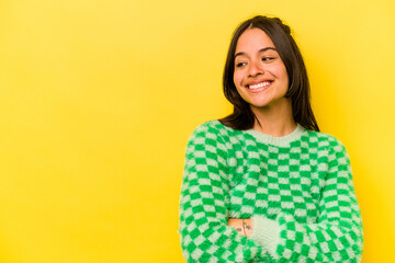 Fototapeta premium Young hispanic woman isolated on yellow background smiling confident with crossed arms.