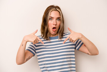 Young caucasian woman isolated on white background points down with fingers, positive feeling.