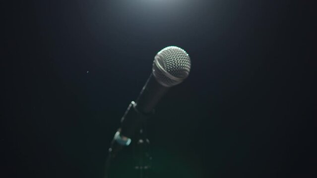 Microphone close-up, mic isolated on black background. Karaoke singing, nightlife club or bar. Music, musical concert.