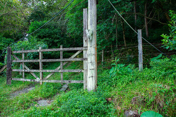 wooden gate at the entrance of a farm with an ox head hanging from it