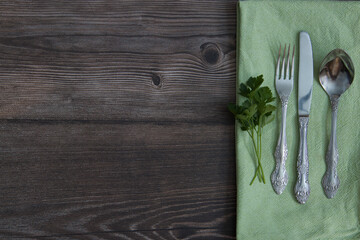 fork, spoon and knife on a wooden table
