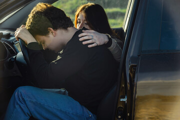 the driver is a young man upset, he lies on the steering wheel and does not want to go, next to him...