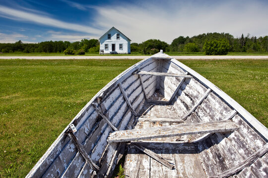 Old boat wreck and Vilhjalmur Sigurgeirsson Log House.  Hecla Village, Hecla Island Provincial Park, Manitoba, Canada.