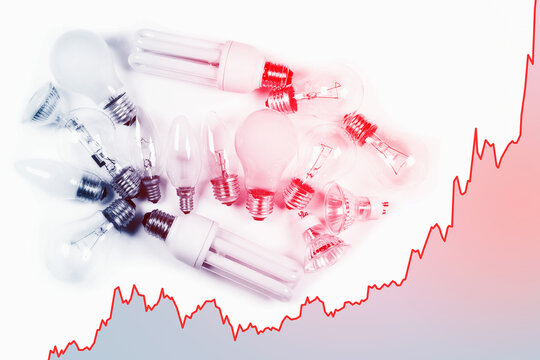 Light bulbs and rising chart representing current electricity price during energy crisis in the world