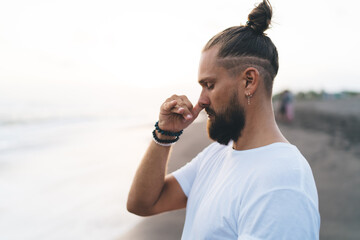 Harmony and meditation training during morning yoga at coastline, Caucaisan bearded male in...