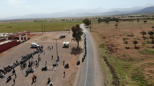 Drone view for a Group Of Motorcyclists On A Sunny Day in the Agafay Desert, Marrakech, Moroccan - 08 MAY 2022