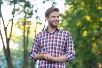 Naklejka na ściany i meble happy young man in checkered shirt outdoor