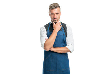 Serious barman in bow and bartender apron stroking chin isolated on white