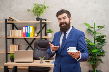 positive mature entrepreneur in jacket having coffee break at office, guy