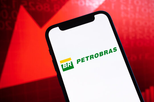 Petrobras oil prices, logo close-up. Collapse, petroleum crisis, red arrow down on stock market graphs background photo