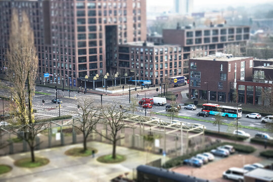 Tilburg city intersection, with cars, bus and high buildings. 