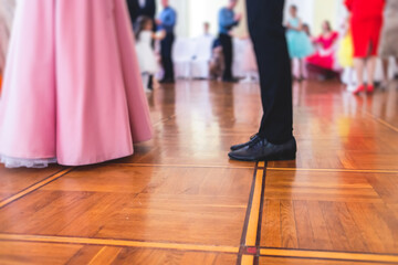 Couples dance on the historical costumed ball in historical dresses, classical ballroom dancers dancing, waltz, quadrille and polonaise in palace interiors on a wooden floor, charity event