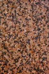 Background and texture granite stone with black inclusions.