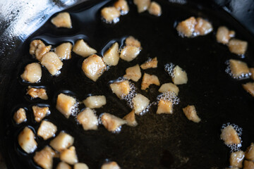 The greaves are fried in a pan. Traditional food of Ukrainians