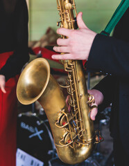 Concert view of saxophonist, saxophone sax player with vocalist and musical during jazz orchestra performing music on stage