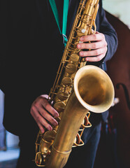 Concert view of saxophonist, saxophone sax player with vocalist and musical during jazz orchestra...