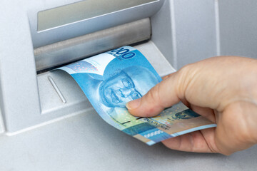 Indonesian rupiah withdrawn from the ATM, Financial and economic concept related to inflation and...