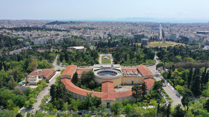 Fototapeta premium Aerial photo taken by drone of iconic public Zappeio hall used for events and whole Athens cityscape at the background, Attica, Greece
