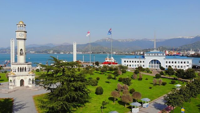 The flag of Georgia is fluttering in the wind.  Sea port in Batumi.