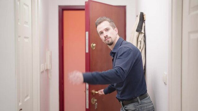 Man in elegant shirt at home open door and show way out funny gesture 4K