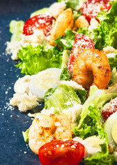 Fresh and tasty salad with grilled shrimps and fresh vegetables.