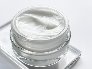 Face cream moisturiser jar and product sample on glass, beauty and skincare, cosmetic science